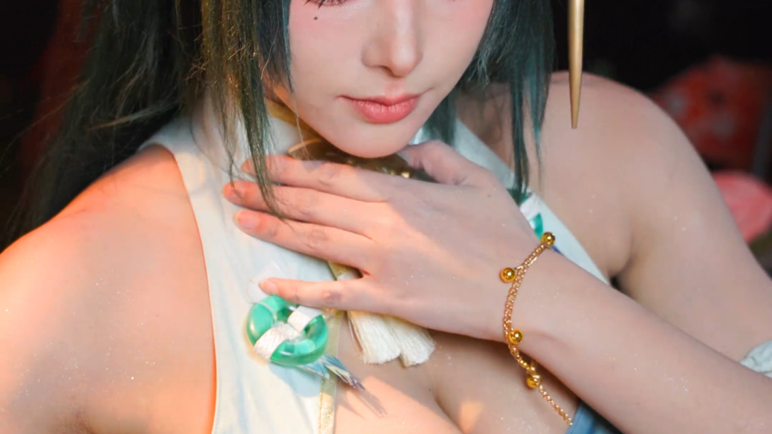 She shyly retreats, leaning against the door to glance back, Yet she sniffs the green plum blossoms.