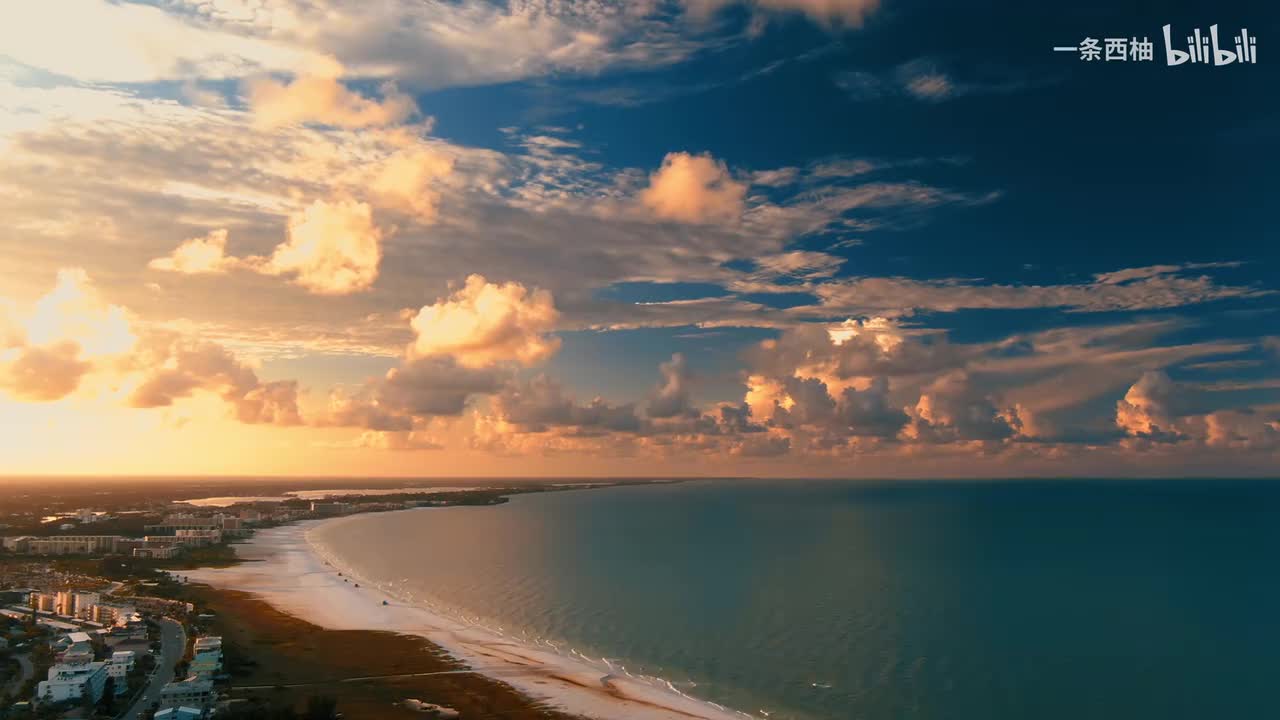 航拍金色日落海边白云