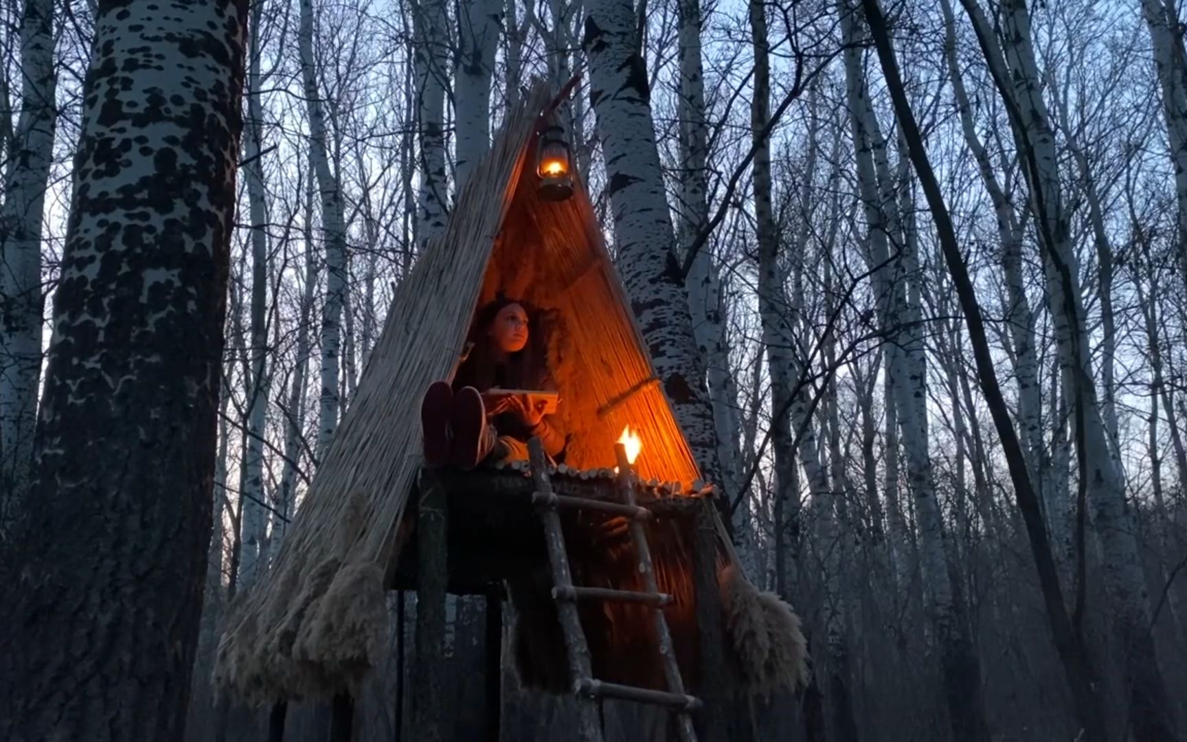 女孩野外露营制作防雨庇护所一人在森林里过夜